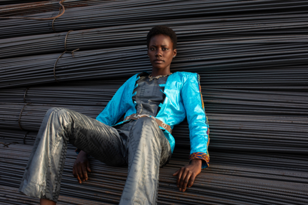 Model sitting on big cable looms